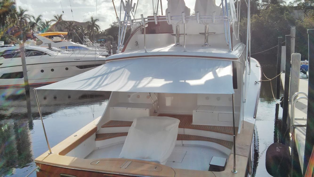 Boat docked at Coconut Grove Marina with white aft deck boat shade  